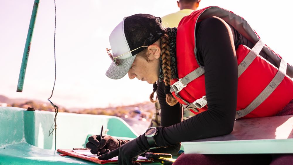 Marine biologist working on boat.