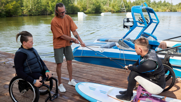 Water sports instructor teaching disabled students.