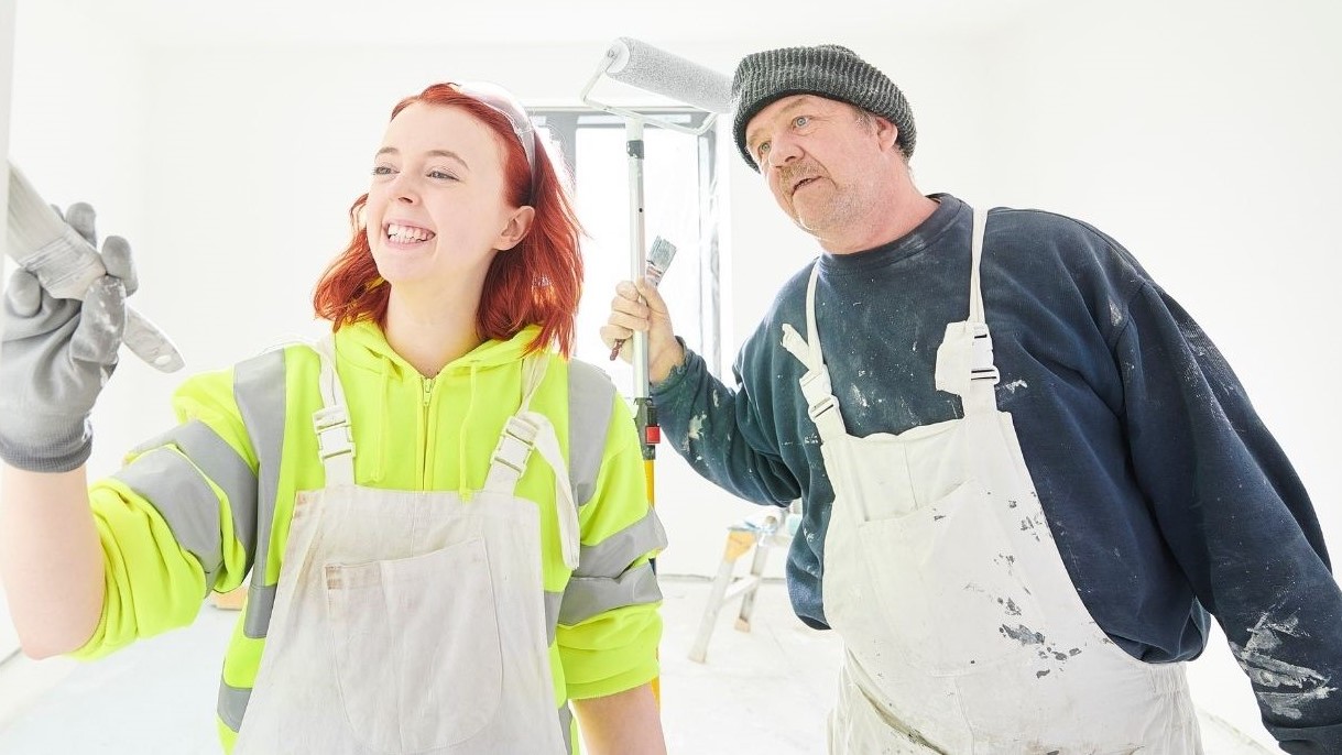 apprentice being shown how to paint