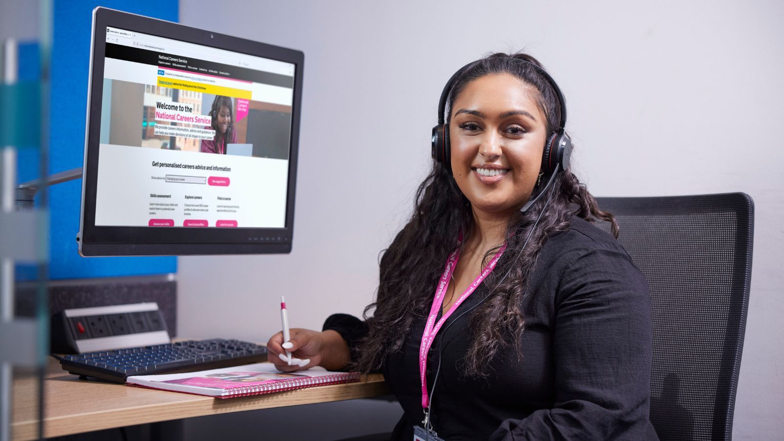 A women sitting at a desk with the website National Careers Service website on her screen.